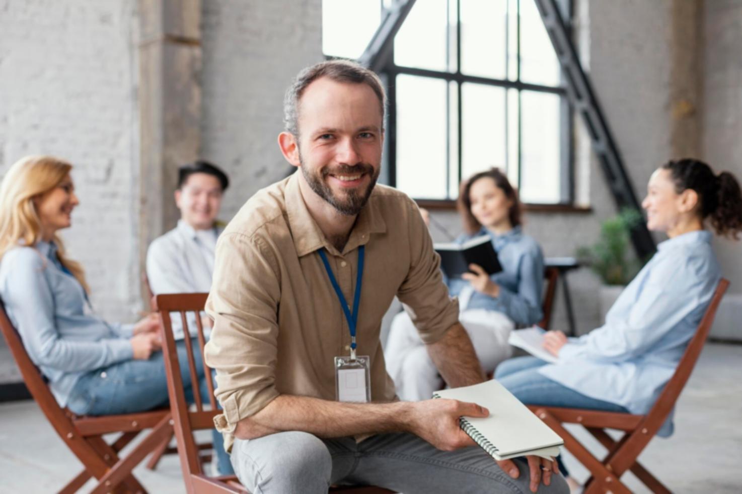 Professional engaged in budget discussion with documents and laptop